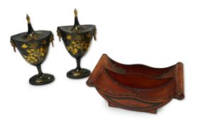 A pair of early 19th century Dutch japanned pewter chest urns and covers, and a tole ware cheese coa
