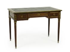 An early 20th century Louis XVI style brass mounted mahogany writing table
