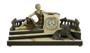 A French Art Deco onyx and patinated spelter clock surmounted with a lady and a black panther on a s