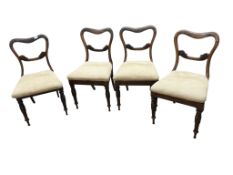 A set of four early Victorian rosewood dining chairs with drop in seats