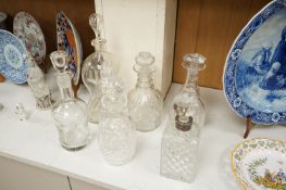 Six 19th century and later cut glass decanters and stoppers, one with white metal acorn design