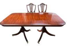 A reproduction mahogany twin pillar extending dining table, 216cm extended, one spare leaf, depth