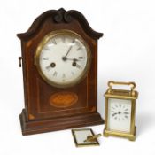 An early 20th century inlaid mantel clock with key and pendulum and a brass cased carriage