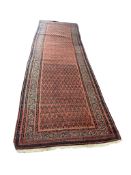 An Ashfar red ground runner, with all over boteh design, 360 x 108cm