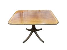 A Regency satinwood banded rectangular mahogany tilt top dining table, on four outswept legs,