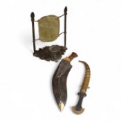 An Indian Kukri with brass mounted wooden handle its leather sheath, and a Moroccan Jambiya,
