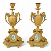 A pair of 19th century gilt metal candlesticks with inset porcelain panels, 32cm high