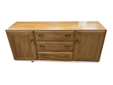 An Ercol Windsor elm sideboard, width 155cm, depth 43cm, height 69cm