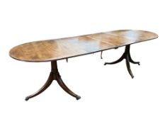 A George III style mahogany twin pillar 'D' end extending dining table, width 260cm extended, two
