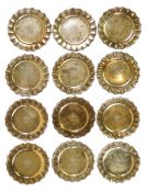 A set of twelve George V silver gilt side plates by J.S. Harman & Co