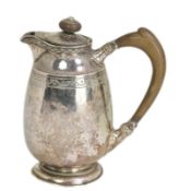 A George V Arts & Crafts silver hot water pot by Liberty & Co