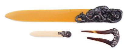 Two paper knives and a hair ornament, early 20th century