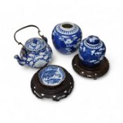 An 18th century Chinese blue and white dish, two jars (one without cover), a teapot and two carved