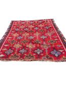 A Turkish Anatolian polychrome flatweave Kilim carpet, woven with geometric lozenges on a red field,