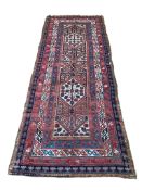 An antique Caucasian red ground runner, 260 x 102cm