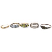 Five rings, comprising: a peridot and diamond ring and a blue topaz ring, each mounted in 9ct