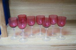 A set of eight cranberry bowl, flute stemmed wine glasses, 16.5cm high