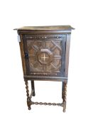 A 17th century style oak cabinet on stand, width 64cm, depth 39cm, height 120cm