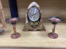 An early 20th century French rouge and black marble clock garniture with ornamental grape motif