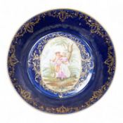 A 19th century Vienna saucer, hand painted with two figures beneath a tree, 15cm in diameter