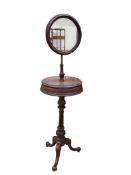 A Victorian mahogany shaving stand, with circular mirror and mid tier compartments, height 153cm