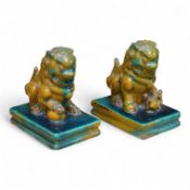A pair of Chinese turquoise and olive green glazed ceramic lion dogs, Guandong kilns, 19th/20th