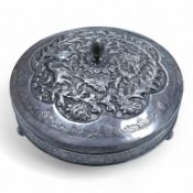 A 20th century Middle Eastern white metal circular box and cover, decorated with birds amongst