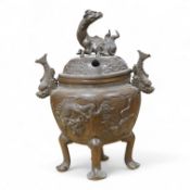 A Japanese bronze koro, raised on four feet with zoomorphic handles and knop, 23cm high
