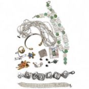 A collection of costume jewels, comprising: a floral coral and nephrite brooch; a composite opal