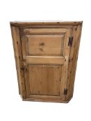 An early 19th century pine hanging corner cupboard, width 67cm, depth 43cm, height 88cm