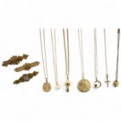 A collection of jewels, comprising: two cross pendants; a heart-shaped locket pendant; a circular