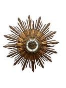 A French giltwood sunburst wall timepiece, with enamelled Roman chapter ring and visible figural