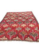 A Turkish Anatolian Kilim polychrome flatweave carpet, woven with geometric lozenges, on a pink
