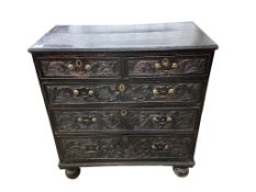 An 18th century oak chest, fitted with two short and three long drawers, later carved, width 89cm,
