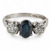 A sapphire and diamond ring, claw-set with an oval sapphire measuring approximately 6.2 x 4.5 x 3.