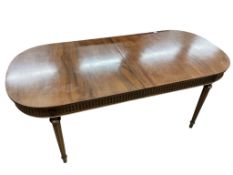 A reproduction Sheraton style mahogany extending dining table, 260cm extended, one spare leaf, width