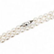 Tiffany & Co., a pair of diamond earrings and a cultured pearl necklace, the earrings of cross