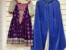 A child’s theatrical brocade dress and a lady’s blue velvet, cream and silk-lined cape, labelled