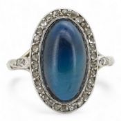 A sapphire and diamond ring, 1920s, set with a cabochon sapphire measuring approximately 2.4 x 6.8 x