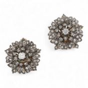 A pair of diamond ear clips 19th century and later, each designed as a wild rose, set with cushion-