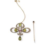 An Art Nouveau peridot, seed pearl and ruby brooch, early 20th century, of scrolled design, set with