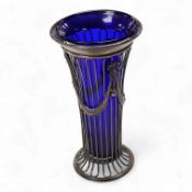 A George V pierced silver trumpet shaped flower vase, with blue glass liner, indistinct maker's