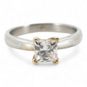 A diamond ring, claw-set with a princess-cut diamond weighing approximately 0.58 carats, mounted