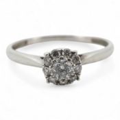 A diamond cluster ring, claw-set with a brilliant-cut diamond weighing approximately 0.10 carats,