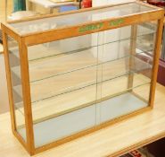 A Dinky Toys glazed oak shop counter retail display cabinet, this is the more scarce ‘front loading’