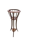 An Edwardian mahogany jardiniere with brass liner, height 85cm