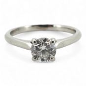 A diamond ring, claw-set with a brilliant-cut diamond weighing approximately 0.61 carats, mounted in