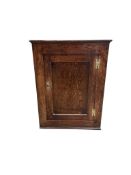 A George III oak hanging corner cabinet, width 63cm, depth 33cm, height 85cm
