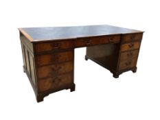 A reproduction George III style mahogany inverse breakfront pedestal desk, width 183cm, depth