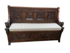 A late 19th century Flemish carved oak settle with hinged box seat, width 160cm, depth 42cm,